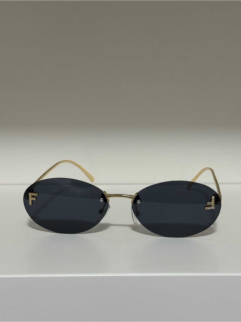 Fendi Gold Frame Oval Sunglasses with Dark Blue Lenses